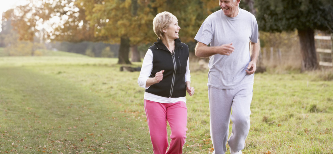Senior Couple Power Walking In The Park